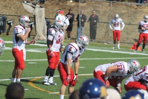 University of the Cumberlands quarterback Adam Craig calls a play from the shotgun with his two dreadlock-donning teammates at his side